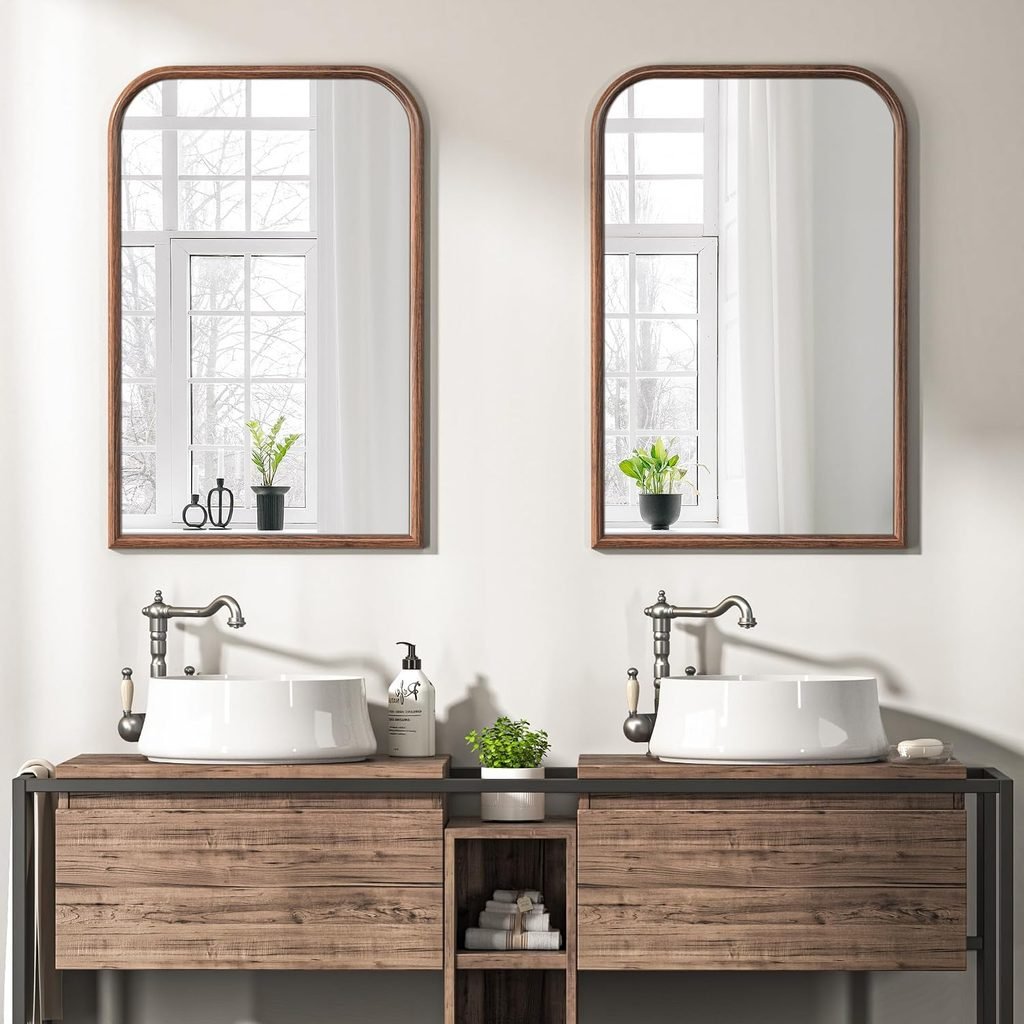Walnut-finish arched mirror for a warm neutral bathroom